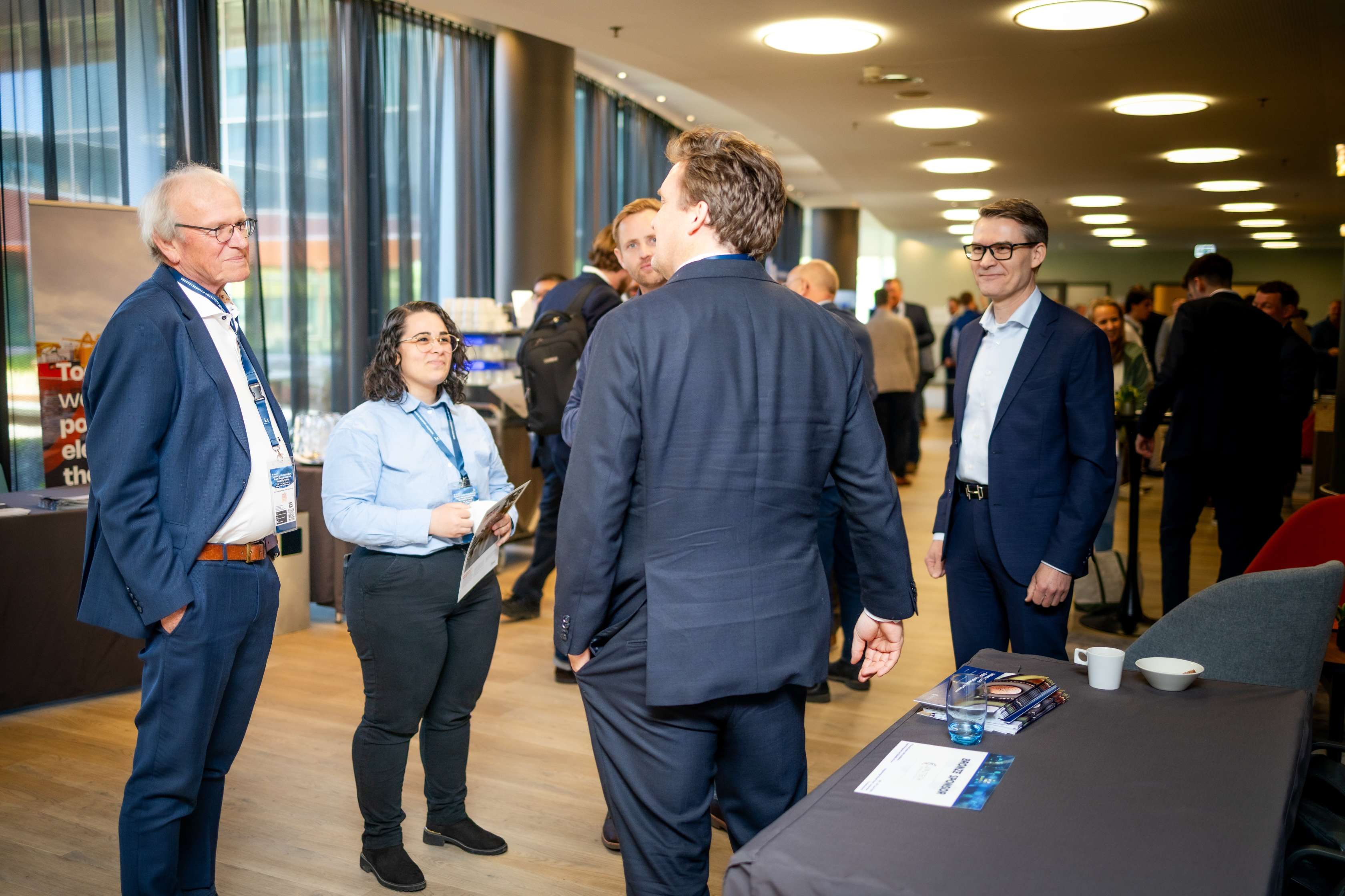 Delegates networking at a sponsor stand during a Leadvent forum