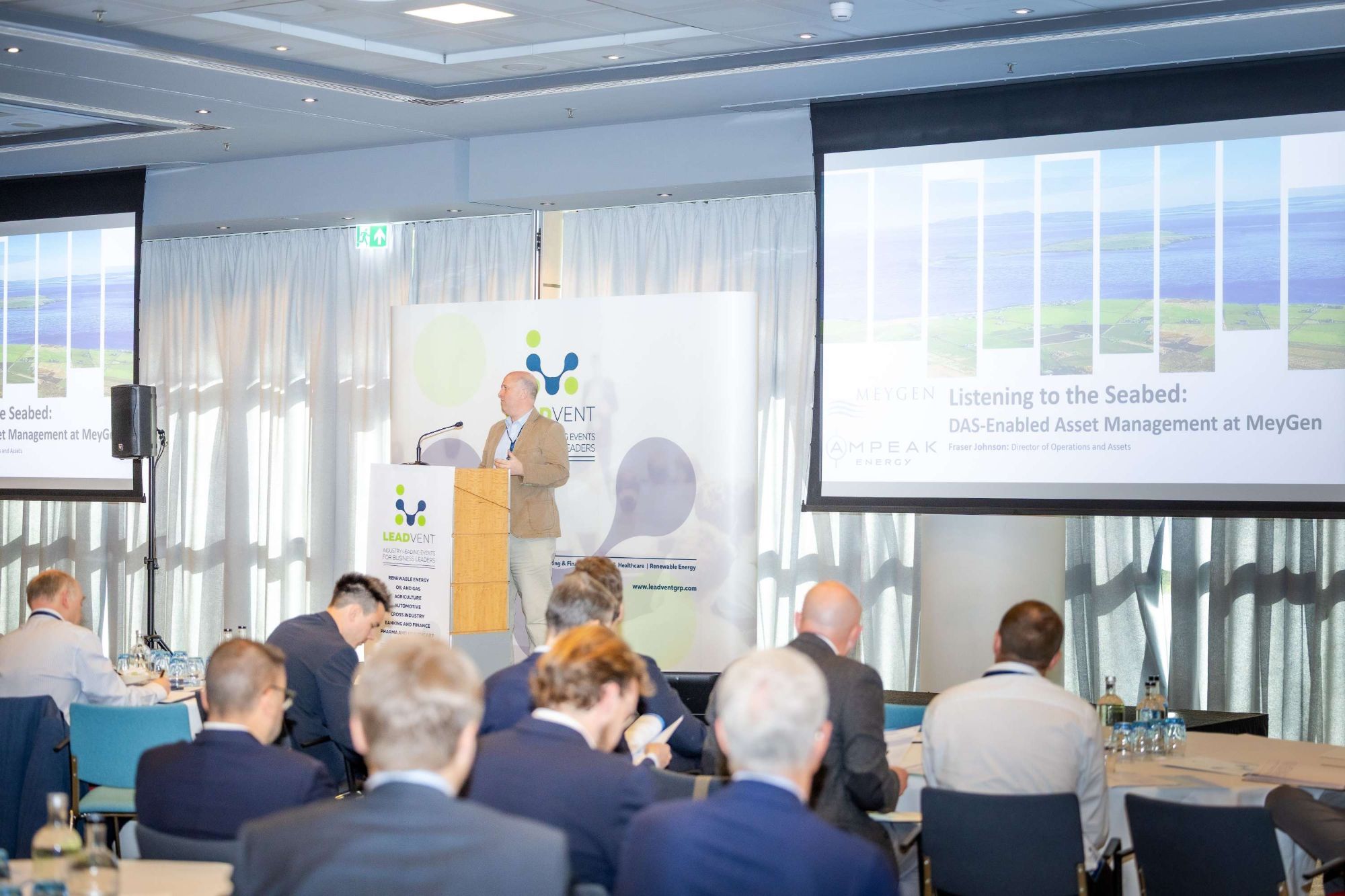 Speaker at the Leadvent Group podium presenting to delegates