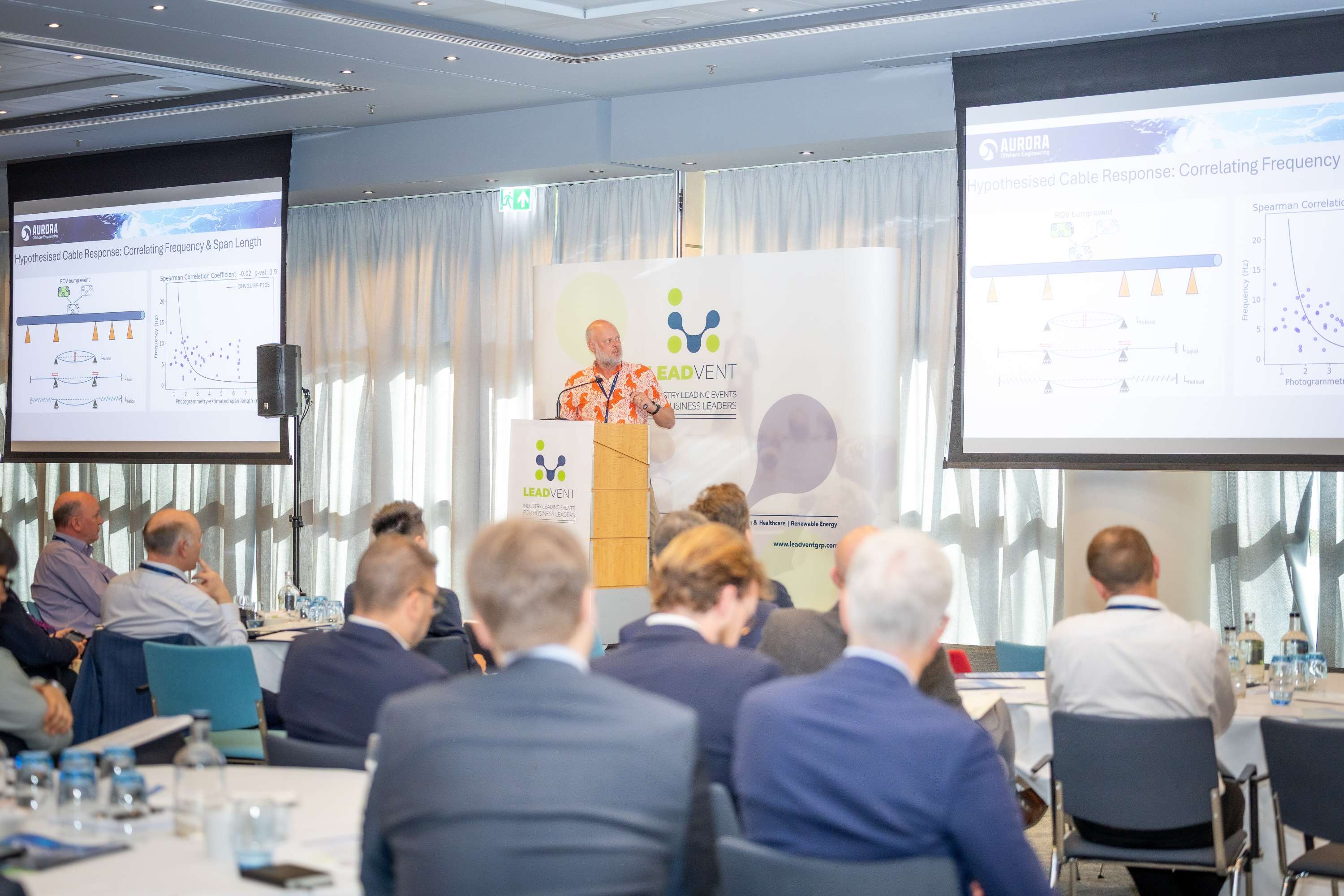 Speaker presenting at the Leadvent podium to conference delegates
