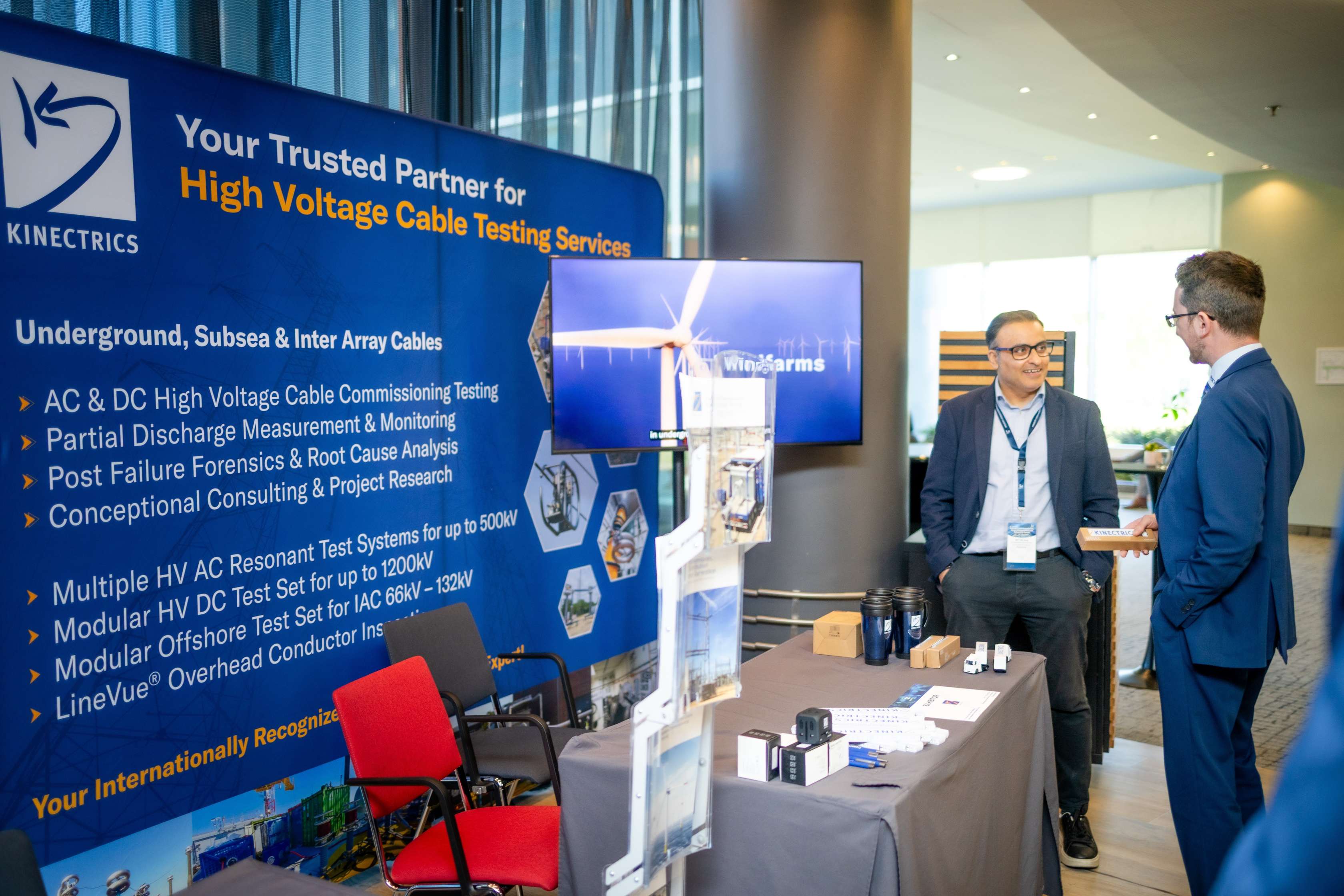 Sponsor exhibition stand with branded backdrop at a Leadvent conference