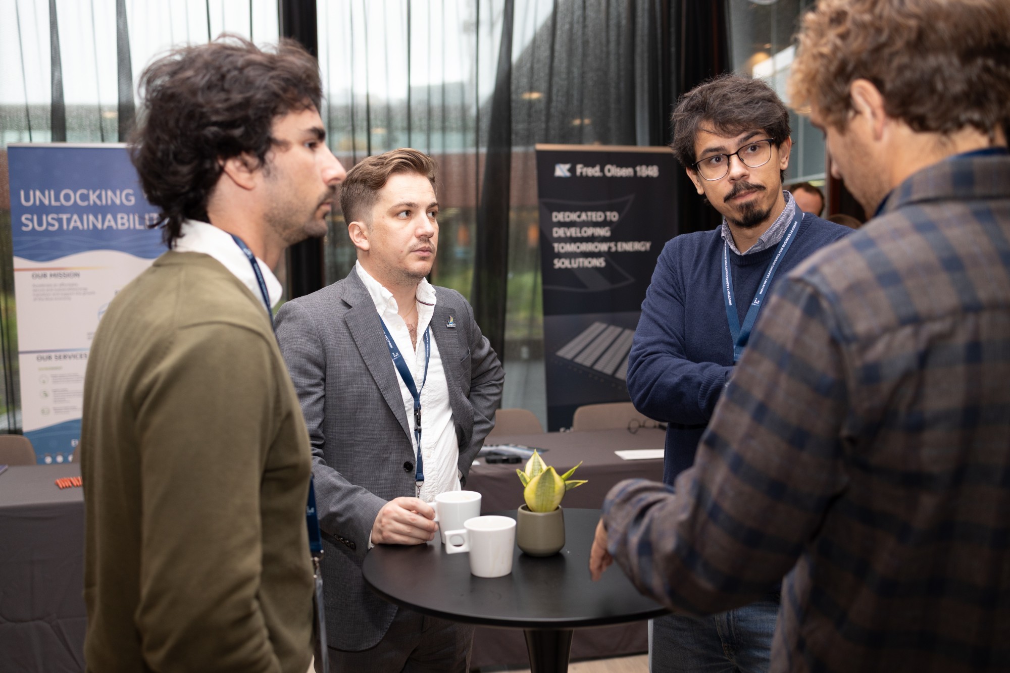 Delegates in conversation at a networking table during a Leadvent event